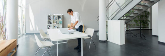 Man working on a table standing up